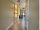 Hallway with a display of shelves, leading into a living area with great natural lighting at 564 Meandering Way, Polk City, FL 33868