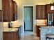 Warm wood cabinets, granite countertops and stainless appliances are featured in this kitchen at 564 Meandering Way, Polk City, FL 33868