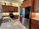 Kitchen boasts stainless steel appliances, granite countertops and backsplash with warm wood cabinets at 564 Meandering Way, Polk City, FL 33868