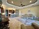 Open-concept living room showcasing the breakfast bar, adjacent kitchen and tan leather sofa at 564 Meandering Way, Polk City, FL 33868