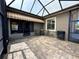 Relax in this screened patio featuring brick flooring and awning, perfect for outdoor entertaining at 564 Meandering Way, Polk City, FL 33868