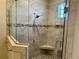 Modern shower with glass door, pebble floor, and stylish tile accents at 564 Meandering Way, Polk City, FL 33868