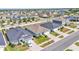 An elevated street view shows many similar homes in the neighborhood on a clear day at 613 Sarner Pass Way, Winter Haven, FL 33881
