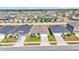A straight on elevated shot shows many similar homes in the neighborhood on a clear day at 613 Sarner Pass Way, Winter Haven, FL 33881