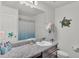 A well-lit bathroom with granite countertops, a decorative turtle, and a combination tub and shower at 613 Sarner Pass Way, Winter Haven, FL 33881