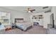Bedroom featuring a large bed, a ceiling fan, and stylish decor for a comfortable and inviting space at 613 Sarner Pass Way, Winter Haven, FL 33881