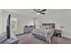 Bedroom with a large bed, a ceiling fan, and a dresser, creating a cozy and relaxing space at 613 Sarner Pass Way, Winter Haven, FL 33881