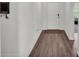 Entryway with hardwood flooring and a white front door, leading into the main living area at 613 Sarner Pass Way, Winter Haven, FL 33881