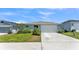 Charming single-story home with a well-manicured lawn, two-car garage, and welcoming entrance at 613 Sarner Pass Way, Winter Haven, FL 33881