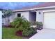 Charming single-story home with a well-manicured front yard and a attached two-car garage at 613 Sarner Pass Way, Winter Haven, FL 33881