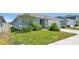 A well-maintained lawn surrounds this lovely home, complete with shrubs and green grass at 613 Sarner Pass Way, Winter Haven, FL 33881