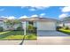 Charming single-story home with a manicured lawn and a two-car garage at 613 Sarner Pass Way, Winter Haven, FL 33881