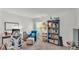 Comfortable home office with desk, chair, shelving, and natural light at 613 Sarner Pass Way, Winter Haven, FL 33881