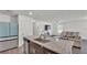Modern kitchen with granite island open to the living area, stainless appliances, and sleek design at 613 Sarner Pass Way, Winter Haven, FL 33881