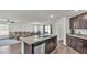 Bright kitchen with granite countertops open to living room and dining area, stainless steel appliances at 613 Sarner Pass Way, Winter Haven, FL 33881