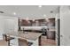 Modern kitchen with granite countertops, stainless steel appliances, and a breakfast bar with seating at 613 Sarner Pass Way, Winter Haven, FL 33881