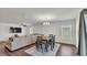 Open concept living and dining area, complete with ceiling fan, hardwood floors, and comfortable seating at 613 Sarner Pass Way, Winter Haven, FL 33881