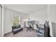 Bright office space featuring a window, sofa, and work desks perfect for remote work at 613 Sarner Pass Way, Winter Haven, FL 33881