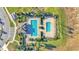 Aerial view of a community pool with lounge chairs and meticulously manicured landscaping at 613 Sarner Pass Way, Winter Haven, FL 33881