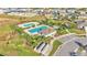 Aerial view of a community pool and recreational area with nearby seating and manicured landscaping at 613 Sarner Pass Way, Winter Haven, FL 33881