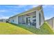 Rear view of home showcasing its screened patio and backyard, perfect for outdoor relaxation at 613 Sarner Pass Way, Winter Haven, FL 33881