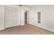 A carpeted bedroom featuring white walls, a large closet and door to the hallway at 697 Broadmoor Cir, Winter Haven, FL 33884