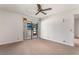 A carpeted bedroom with a ceiling fan and a glass sliding door to the outside at 697 Broadmoor Cir, Winter Haven, FL 33884