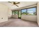 Enclosed lanai featuring walls of windows that provide natural light and views of the yard at 697 Broadmoor Cir, Winter Haven, FL 33884