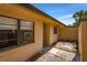 Side view of the home showing the yard space and quaint tiled walkway to the entrance at 697 Broadmoor Cir, Winter Haven, FL 33884