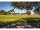 Scenic golf course view featuring a player on the green and golf carts in the background at 697 Broadmoor Cir, Winter Haven, FL 33884