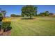 Picturesque golf course view with lush green lawn and mature trees, offering a serene and picturesque setting at 697 Broadmoor Cir, Winter Haven, FL 33884