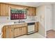Kitchen with double sink, wood cabinets, and a window offering natural light at 697 Broadmoor Cir, Winter Haven, FL 33884