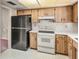 Functional kitchen with wood cabinets, matching appliances, and ample counter space at 697 Broadmoor Cir, Winter Haven, FL 33884