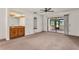 Large living area with wet bar, ceiling fan and sliding glass doors to the Florida room at 697 Broadmoor Cir, Winter Haven, FL 33884