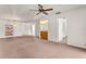 Expansive living space with neutral carpet, a bar area, and access to other rooms at 697 Broadmoor Cir, Winter Haven, FL 33884