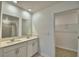 Spacious bathroom with double sinks, modern fixtures, and tile shower, leading into closet at 752 Reggie Rd, Winter Haven, FL 33884