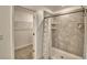 Modern bathroom features a tiled shower with a shower caddy and neutral-toned tile flooring at 752 Reggie Rd, Winter Haven, FL 33884