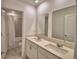 Bright bathroom featuring double sinks, white cabinetry, and a tiled shower/tub combination at 752 Reggie Rd, Winter Haven, FL 33884