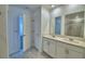 Bright bathroom featuring double sinks, white cabinetry, and tiled flooring at 752 Reggie Rd, Winter Haven, FL 33884