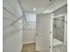 Walk-in closet connects to a tiled shower featuring a neutral-toned tile flooring and an open door at 752 Reggie Rd, Winter Haven, FL 33884