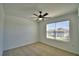 Bedroom featuring neutral carpet, ceiling fan, and a window with view at 752 Reggie Rd, Winter Haven, FL 33884