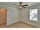 Neutral bedroom with a ceiling fan and window with blinds at 752 Reggie Rd, Winter Haven, FL 33884
