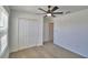 A cozy bedroom featuring a ceiling fan, a spacious closet and a carpet floor at 752 Reggie Rd, Winter Haven, FL 33884