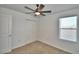 This bedroom has neutral carpet, a window, and a closet at 752 Reggie Rd, Winter Haven, FL 33884