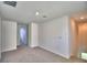 This bedroom has neutral carpet and multiple doorways leading to other spaces at 752 Reggie Rd, Winter Haven, FL 33884