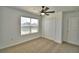 A cozy bedroom featuring a ceiling fan, a window and a spacious closet at 752 Reggie Rd, Winter Haven, FL 33884