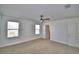 Serene bedroom with carpeted flooring, a ceiling fan, and ample natural light from the windows at 752 Reggie Rd, Winter Haven, FL 33884