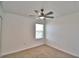 Bedroom featuring neutral carpet, ceiling fan, and a window with view at 752 Reggie Rd, Winter Haven, FL 33884