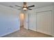 Carpeted bedroom featuring a ceiling fan, closet, and bright white walls at 752 Reggie Rd, Winter Haven, FL 33884