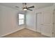 This bedroom has neutral carpet, a ceiling fan, a window, and a closet at 752 Reggie Rd, Winter Haven, FL 33884